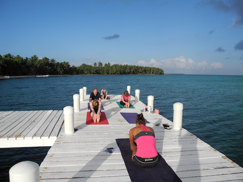 Yoga on the dock at Half Moon Caye, Belize